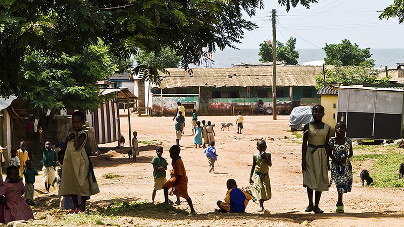 Children playing in street in village.